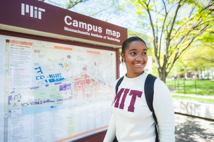 Woman stands in front of campus map